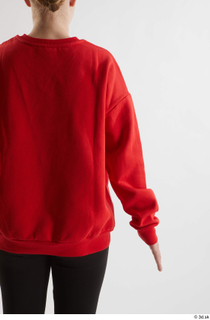 Selin  1 arm back view dressed flexing red hoodie…
